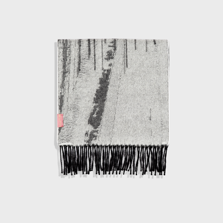 Textured scarf with black fringe on a white background