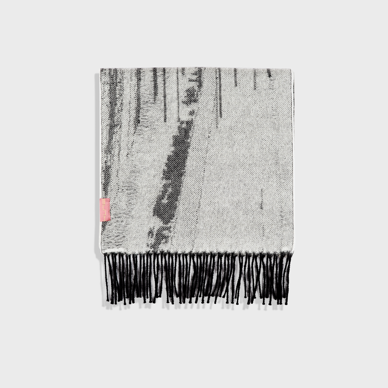 Textured scarf with black fringe on a white background