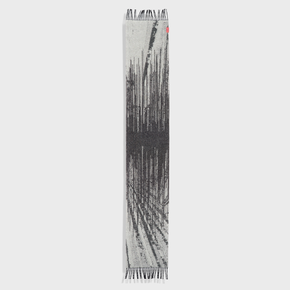 Textured scarf with black and white pattern on a light gray background