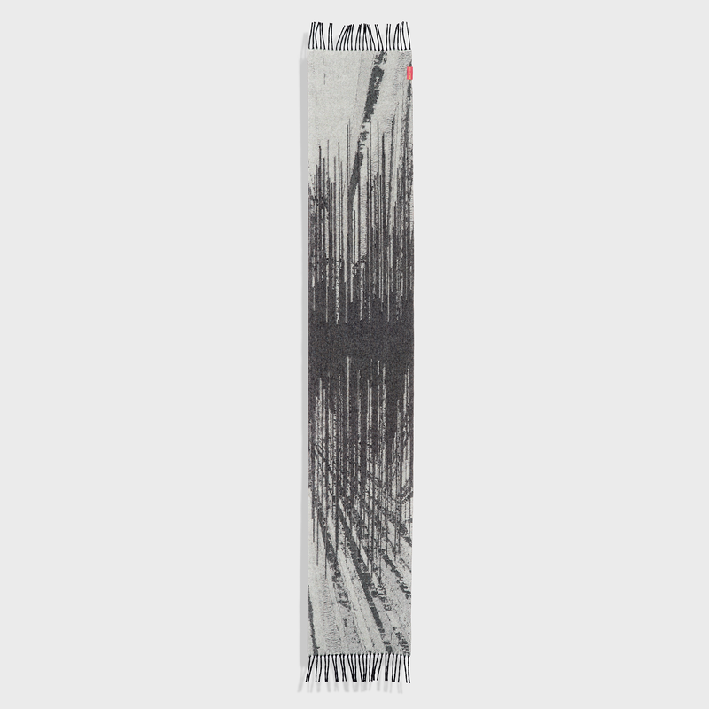 Textured scarf with black and white pattern on a light gray background