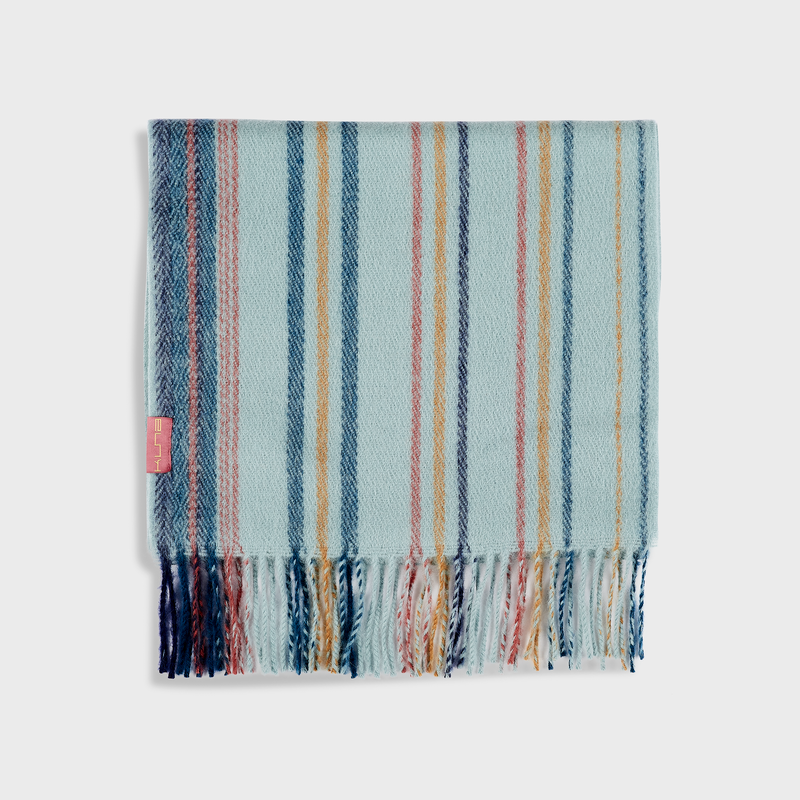 Striped scarf with blue, pink, and white colors on a light gray background