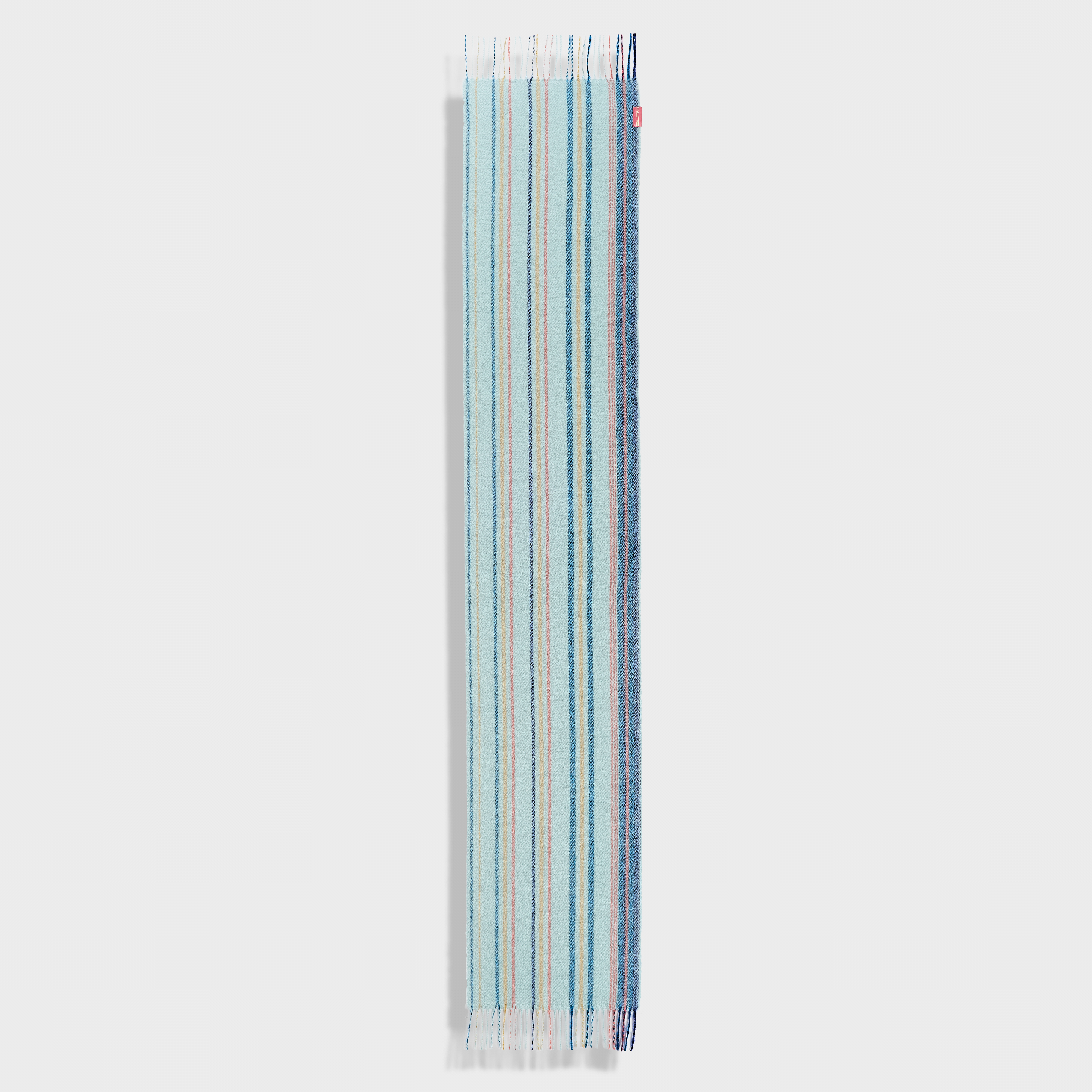 Blue striped scarf with tassels on a light gray background