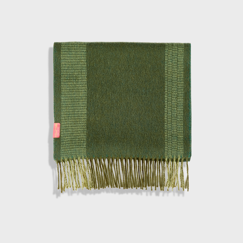 Green scarf with a brand tag on a white background