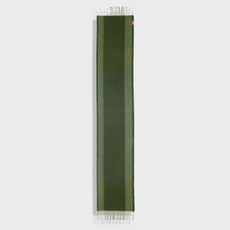 Green scarf with white trim on a light gray background