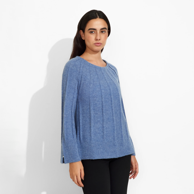 Woman wearing a blue sweater on a white background