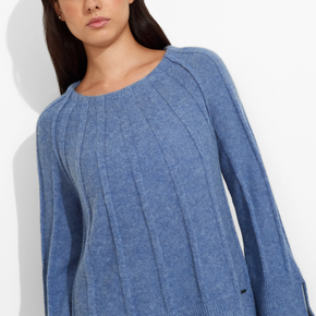 Woman wearing a blue sweater on a white background