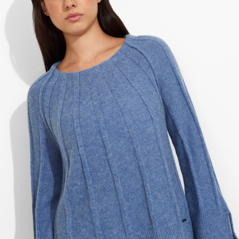 Woman wearing a blue sweater on a white background