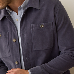 Navy blue shirt with button details on a neutral background