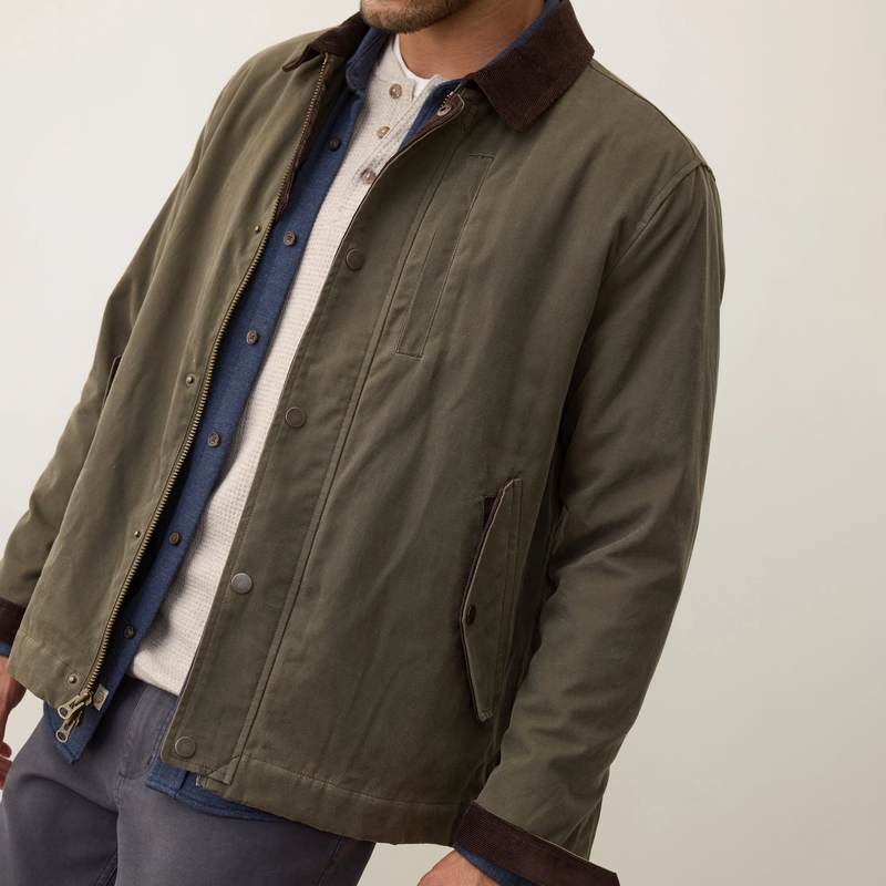 Green jacket worn by a person on a plain background