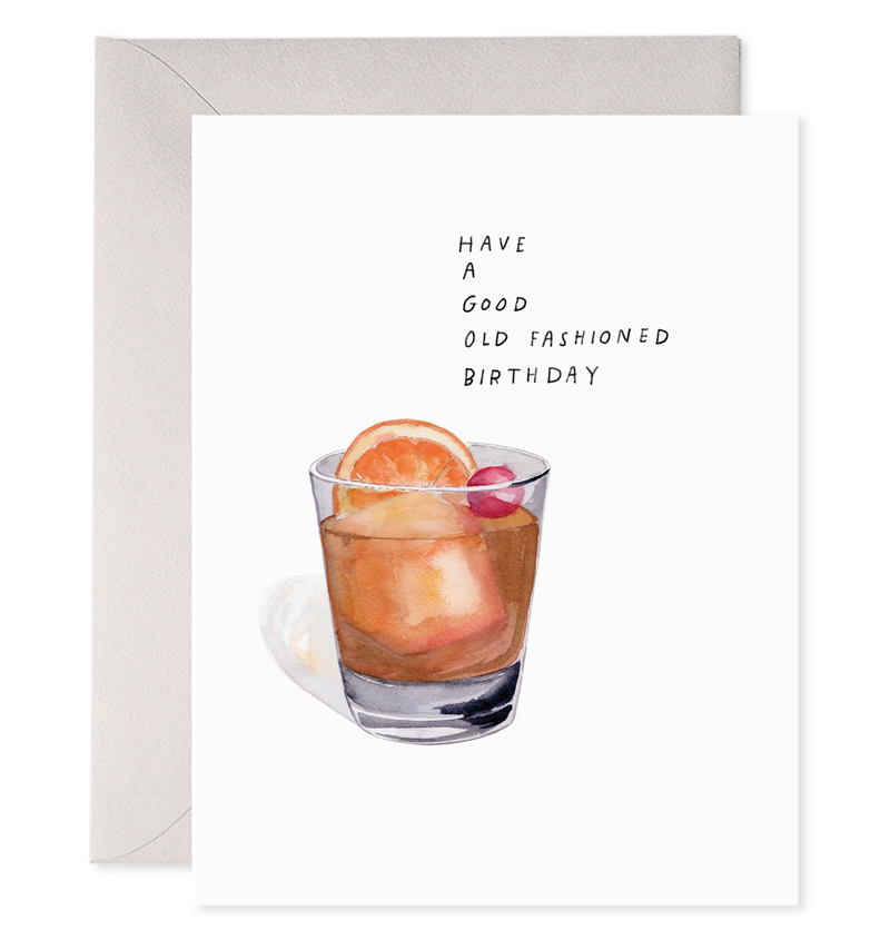 Greeting card with a glass of a drink and text 'Have a good old fashioned birthday' on a white background.