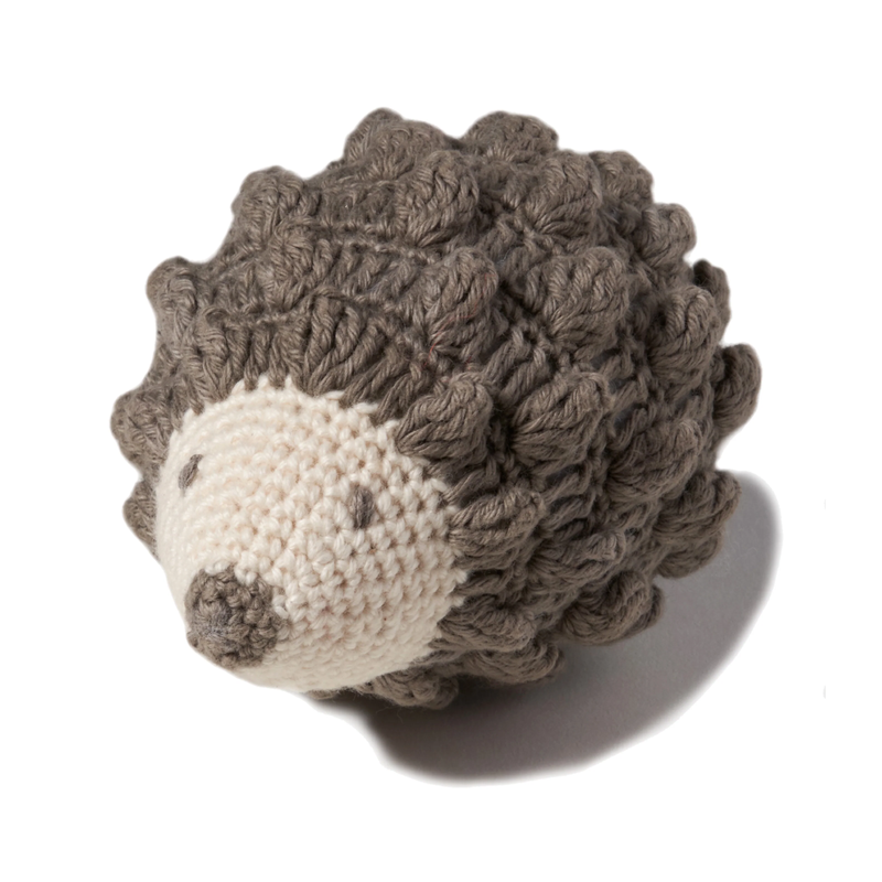 Knitted hedgehog toy on a white background