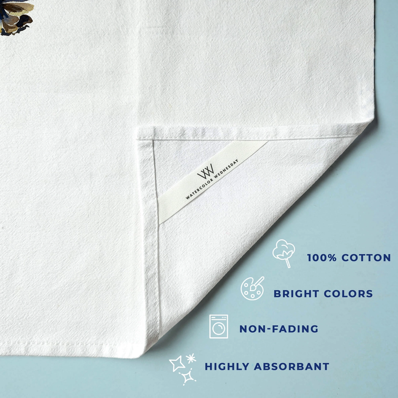 White towel with brand label on a light blue background, featuring text about towel properties.