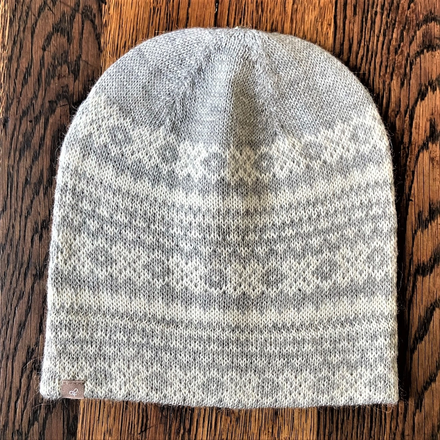 Knitted beanie with a pattern on a wooden surface
