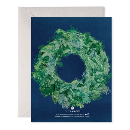 Greeting card with a green wreath design on a blue background, featuring the brand 'E. Frances'.
