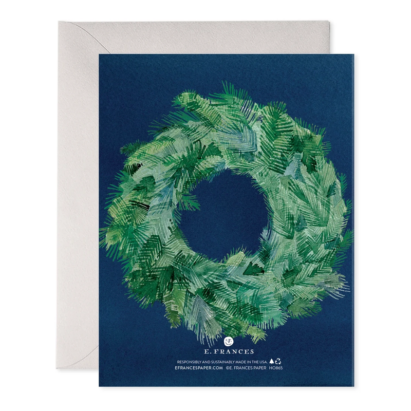 Greeting card with a green wreath design on a blue background, featuring the brand 'E. Frances'.