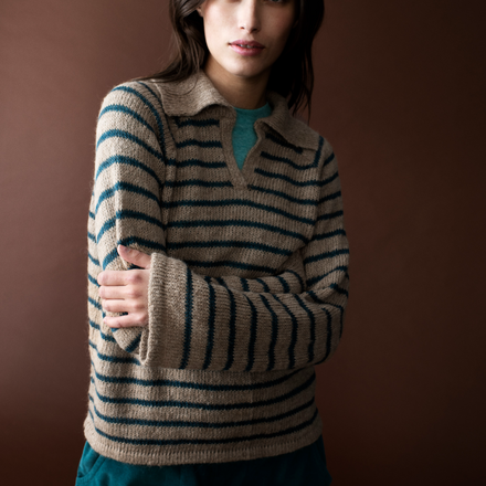 Woman wearing a striped sweater against a brown background