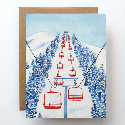Greeting card with a ski lift and snowy landscape design on a white background