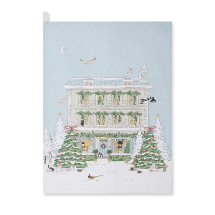 Tea towel with a festive house with Christmas decorations on a snowy background