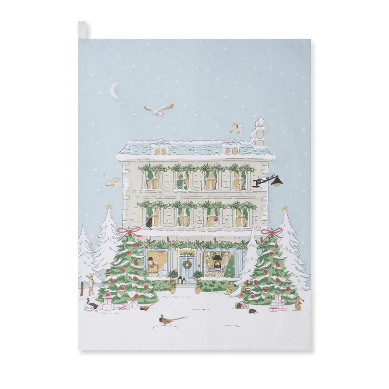 Tea towel with a festive house with Christmas decorations on a snowy background