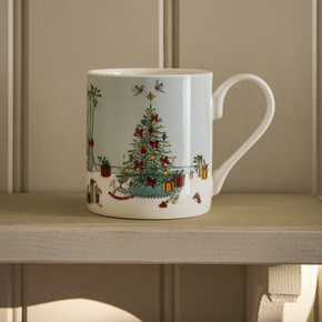 White mug with Christmas tree and gift design on a wooden surface