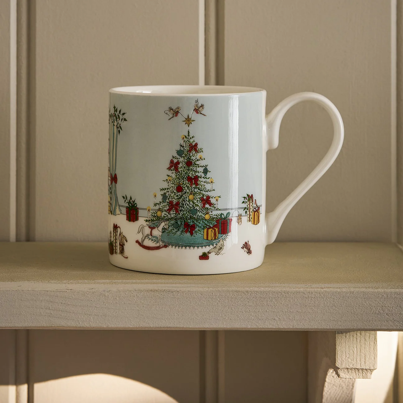 White mug with Christmas tree and gift design on a wooden surface