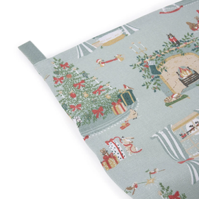 Christmas-themed tea towel with patterns of trees, presents, and houses on a light blue background.