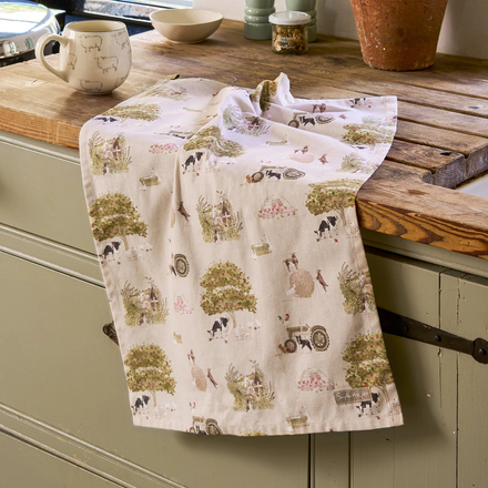 Tea towel with farm animal pattern draped over a kitchen counter