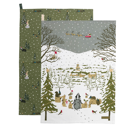 Two Christmas-themed tea towels with winter scenes and festive elements.