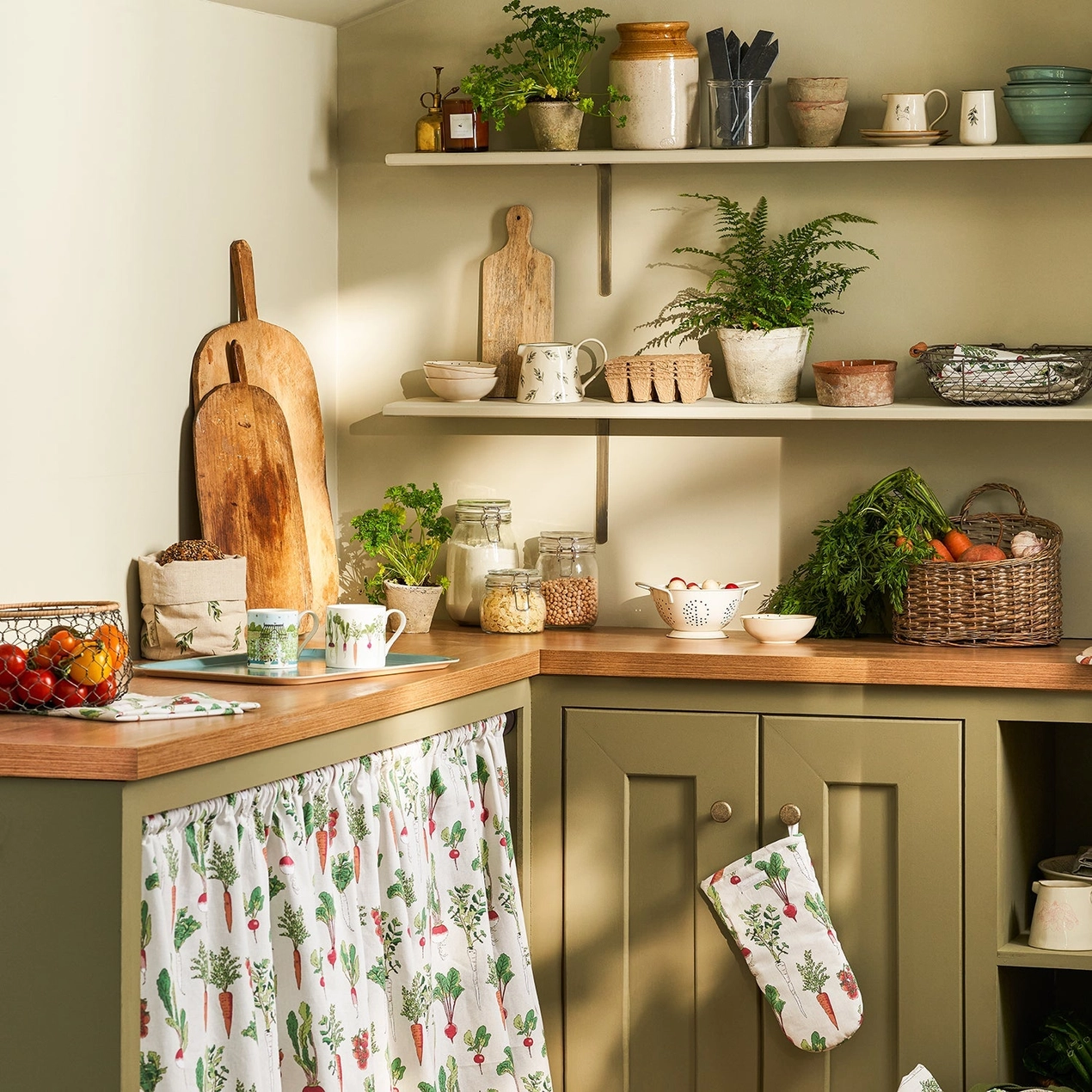 Kitchen with wooden countertops, green cabinets, and various kitchen items.