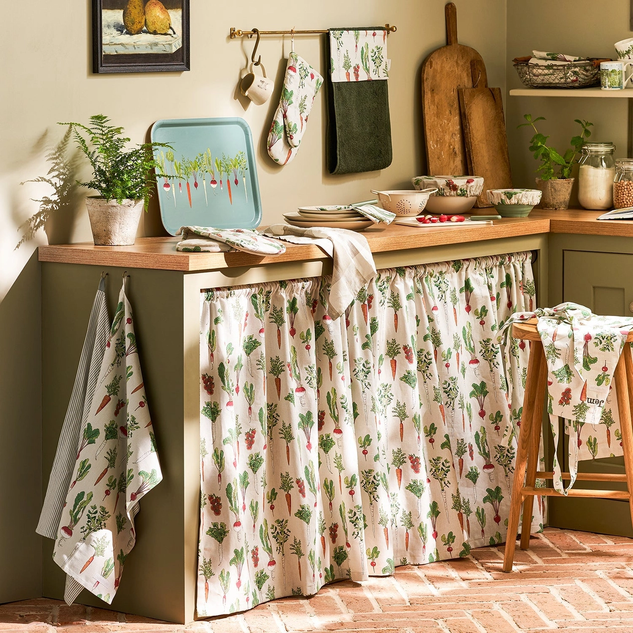 Kitchen with wooden counter, patterned towels, and plants