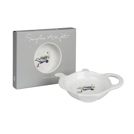 White ceramic tea bag tidy with decorative elements next to a branded box on a white background