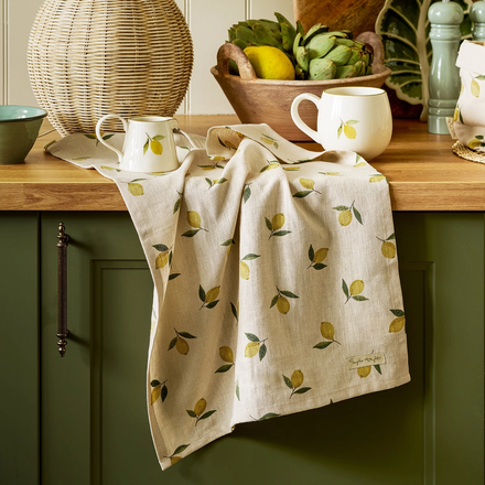 Kitchen towel with lemon pattern on a wooden countertop