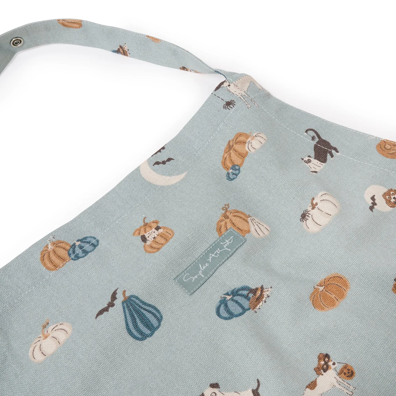 Apron with pumpkin and dog pattern on a light blue background