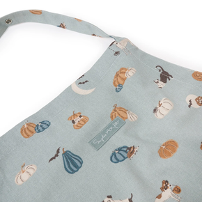 Apron with pumpkin and dog pattern on a light blue background