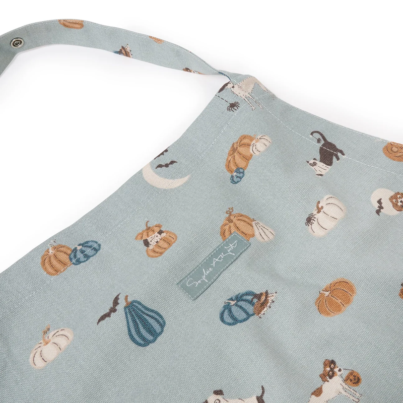 Apron with pumpkin and dog pattern on a light blue background
