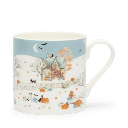 Mug with autumn-themed design featuring a house, pumpkins, and cats on a blue background.
