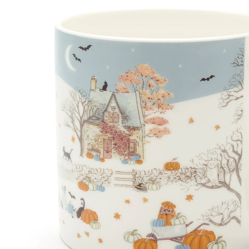 Mug with a fall scene design featuring a house, pumpkins, and animals on a blue background.