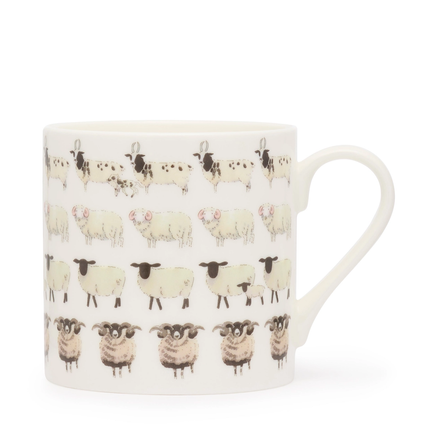 White mug with black and white sheep pattern on a white background