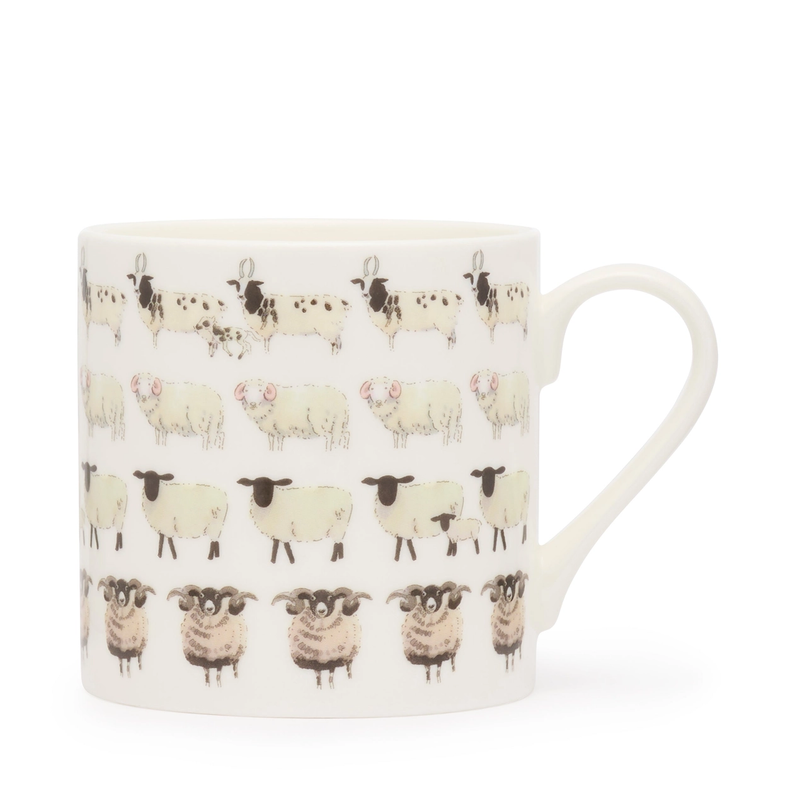 White mug with black and white sheep pattern on a white background