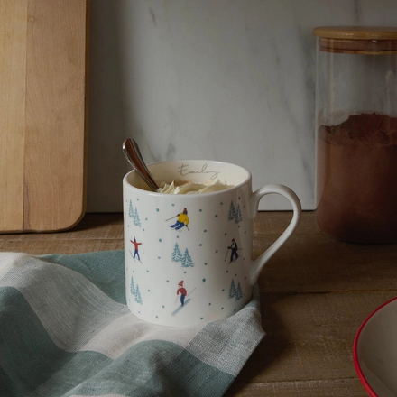 Mug with winter-themed design on a wooden surface