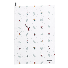 Patterned tea towel with skiers and trees on a white background