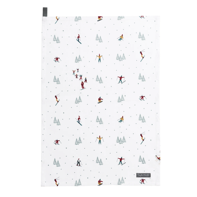 Patterned tea towel with skiers and trees on a white background