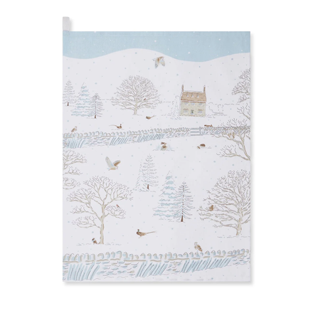 Tea towel winter scene with a house, trees, and birds on a snowy landscape