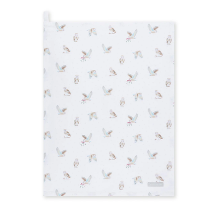 White tea towel with owl pattern on a white background