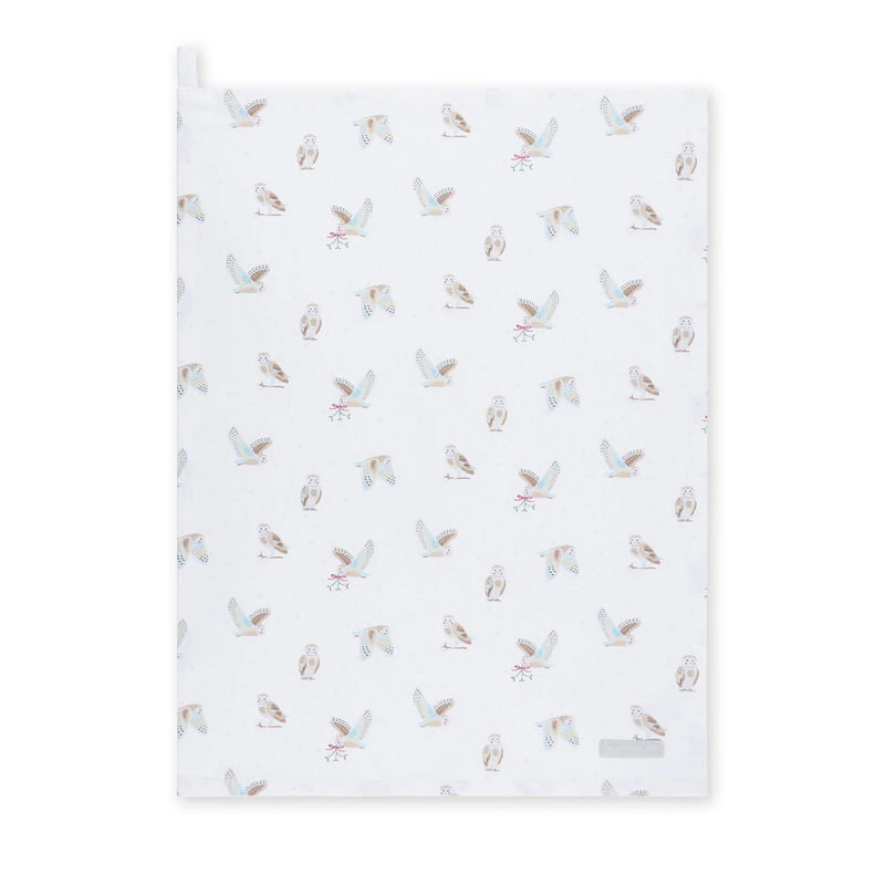 White tea towel with owl pattern on a white background