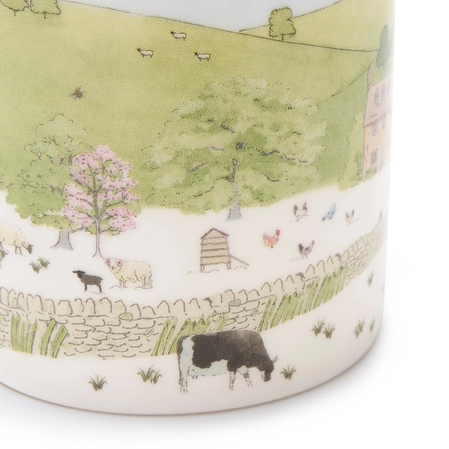 A white fine bone china mug with a spring cottage scene design, including a cottage, blossoming trees, and baby animals.