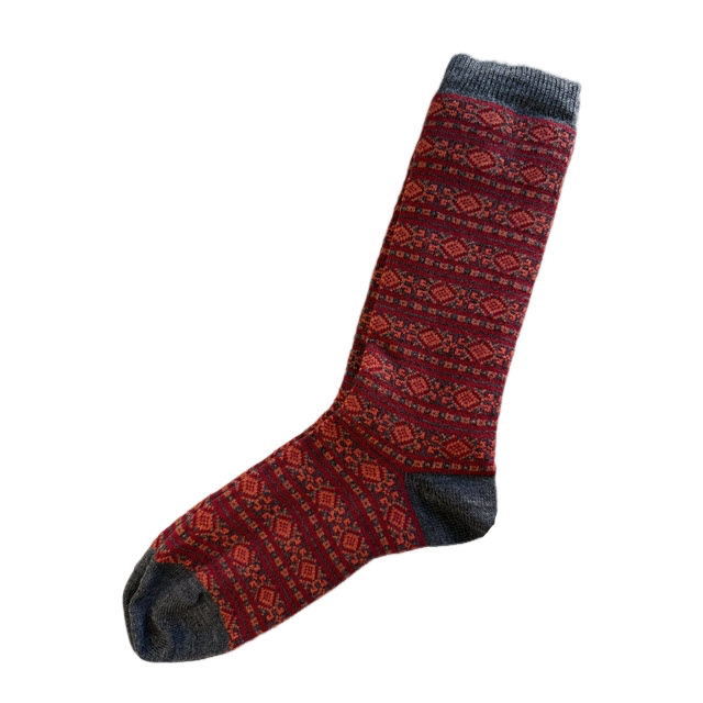 Red patterned sock with gray cuffs and toes on a white background