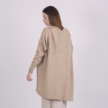 Woman wearing a beige long-sleeve top and pants on a white background