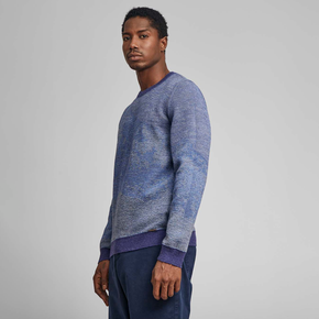 Kuna Huarascan Sweater - model wearing blue reverse side of sweater on a neutral background