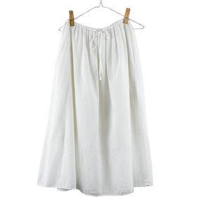 White skirt on a hanger against a white background